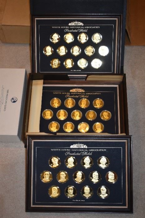 Three boxes of presidential medals are shown.